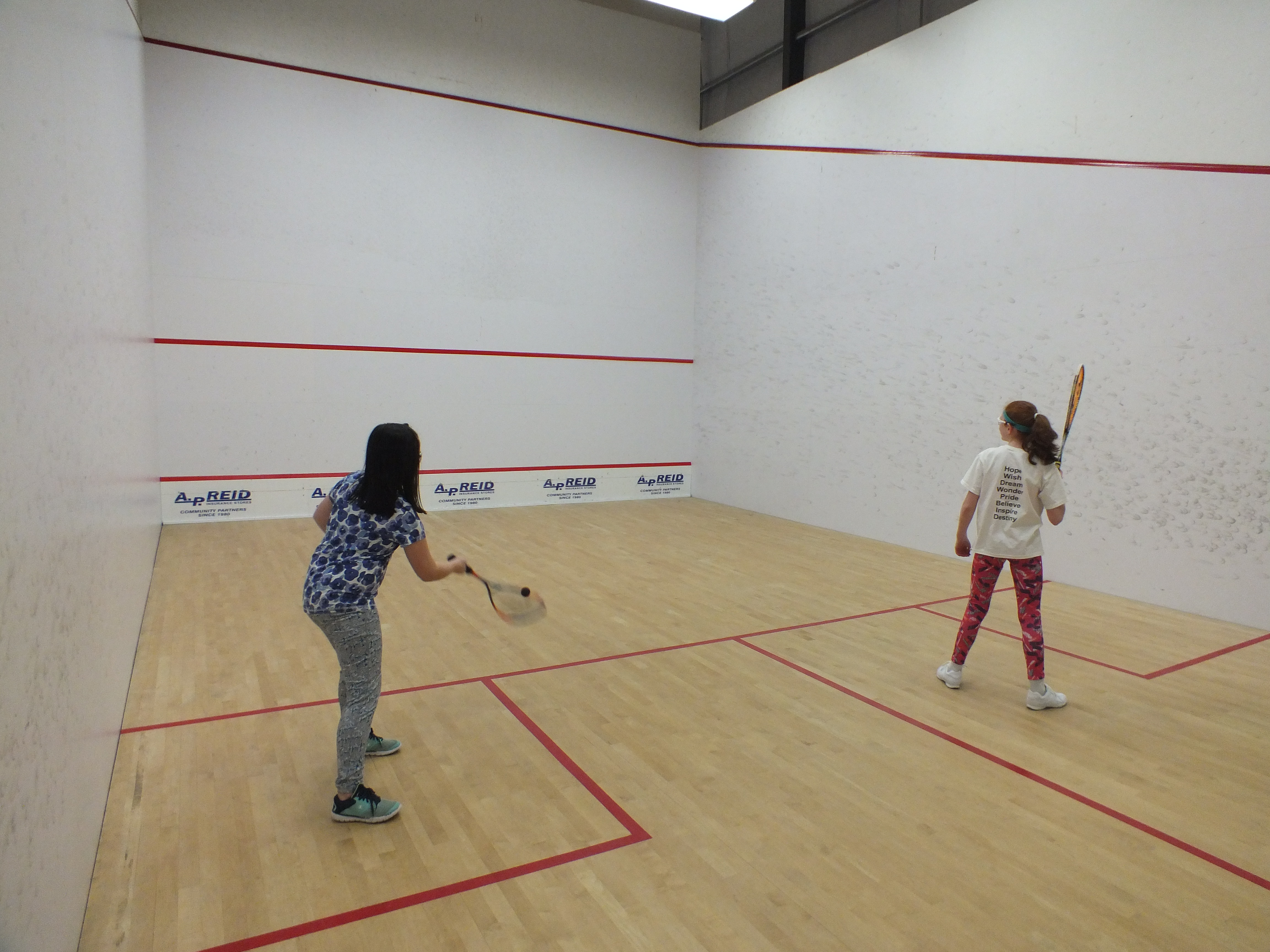 Girls playing squash