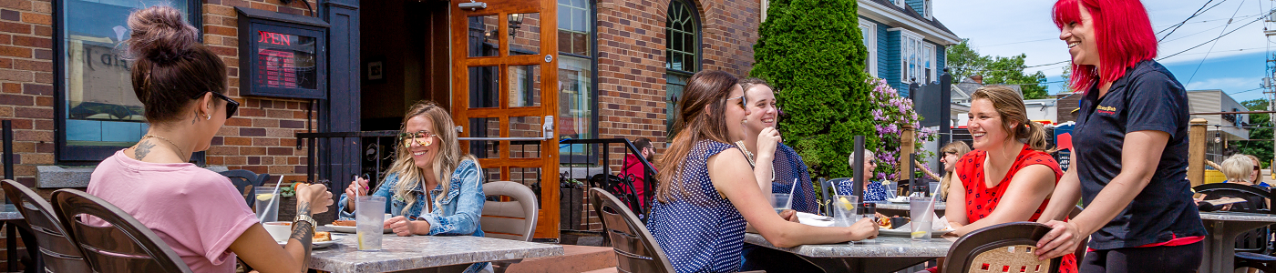 People on patio having a good time eatting at restaurant