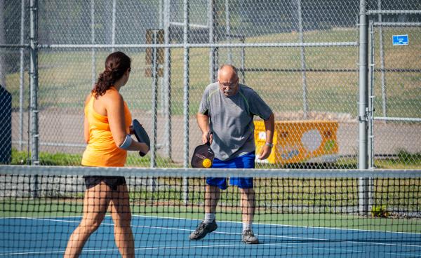 Two people playing pickleball