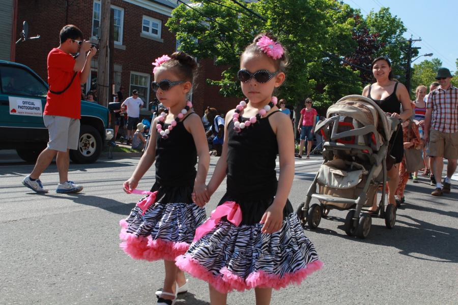 two young girls dressed in costume for the apple blossom festival march in the children's parade